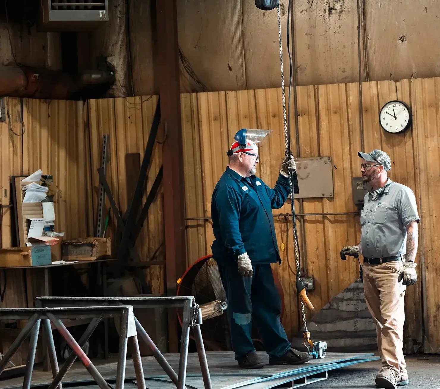 industrial-workers-talking-with-chain-hoist-workshop