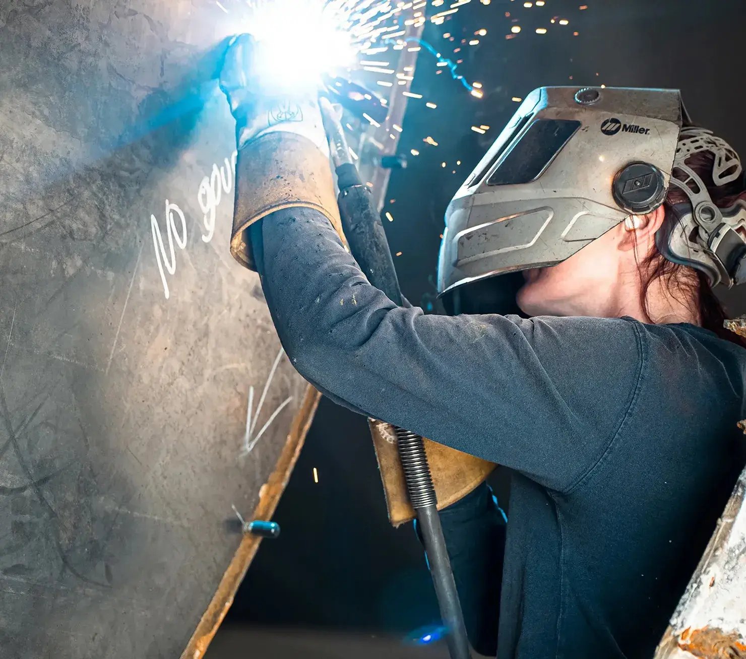 person-welding-metal-with-bright-sparks