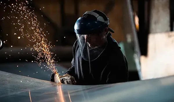 worker-using-angle-grinder-sparks-metalwork